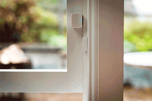 Image of a SimpliSafe contact sensor on an open window for use with triggering an Alexa routine